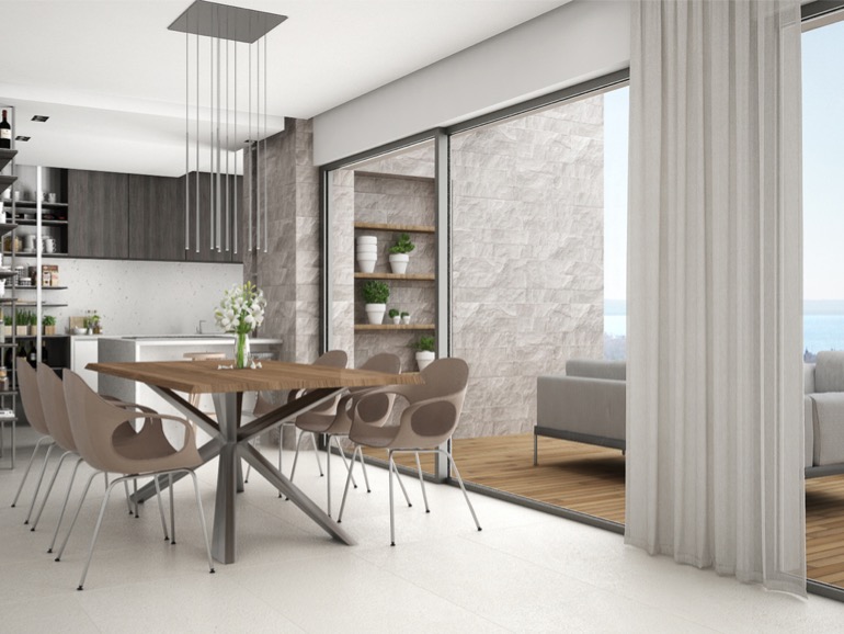 modern-kitchen-with-dining-table-and-chairs-big-panoramic-window-with-picture-id943758250